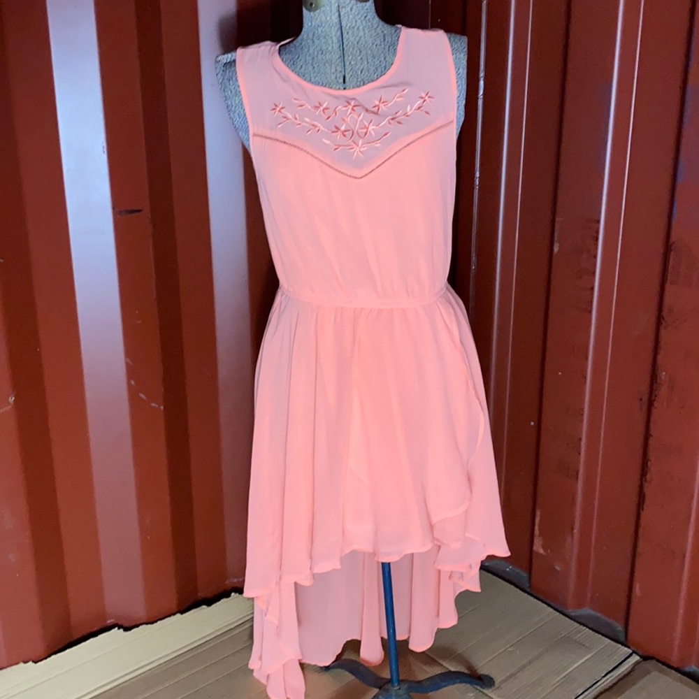 Woman’s coral colored medium dress